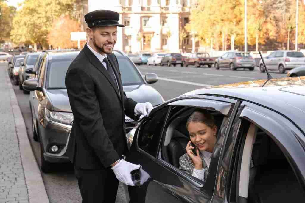 A well-mannered Chauffeur open a door of limo car